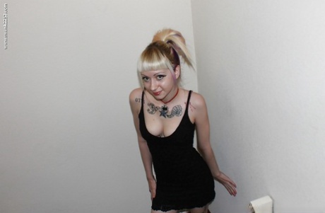 Alternative babe Symone posing for non nude pics in boots and black dress