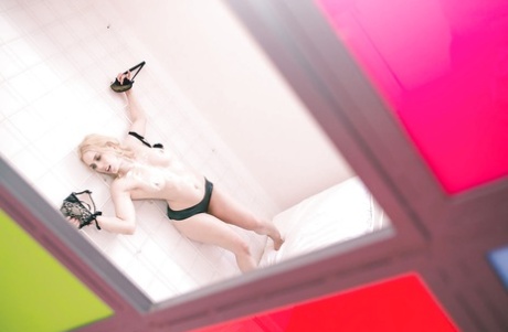 Blonde chick in crotchless latex panties tied to shower stall wall