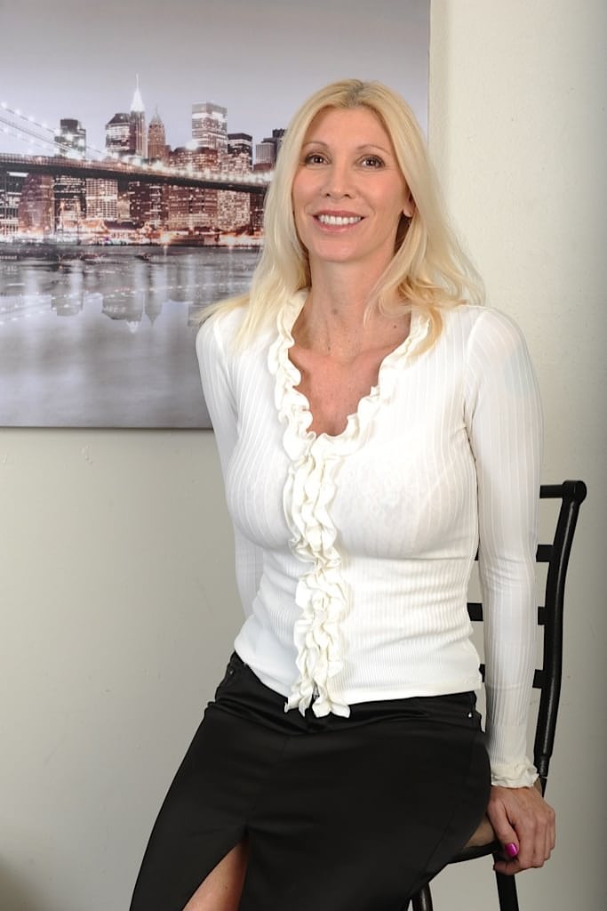 Mature blonde MILF Cameo posing fully clothed in skirt and heels