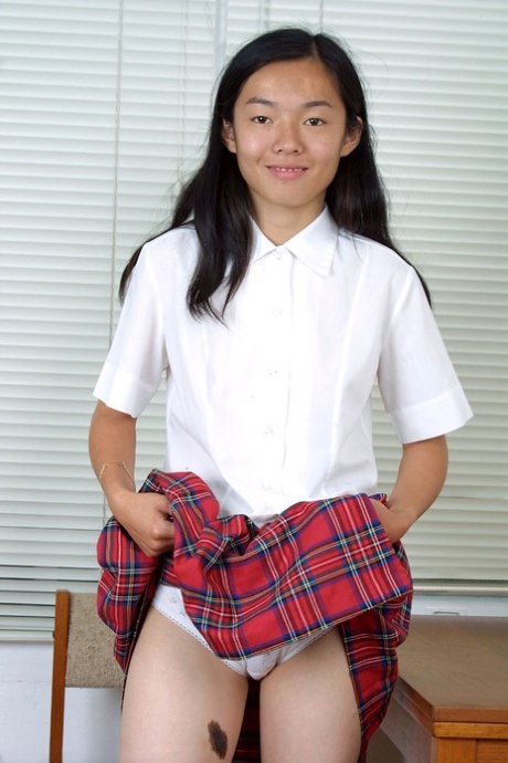 Asian first timer Tiffany removing schoolgirl uniform to pose in nude