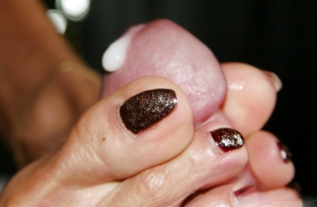 Older British woman Lady Sarah using barefeet to deliver footjob