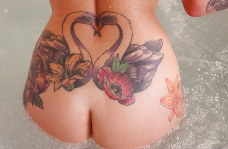 Tattooed solo girl Daniella Mae releasing big tits from bikini in bathroom