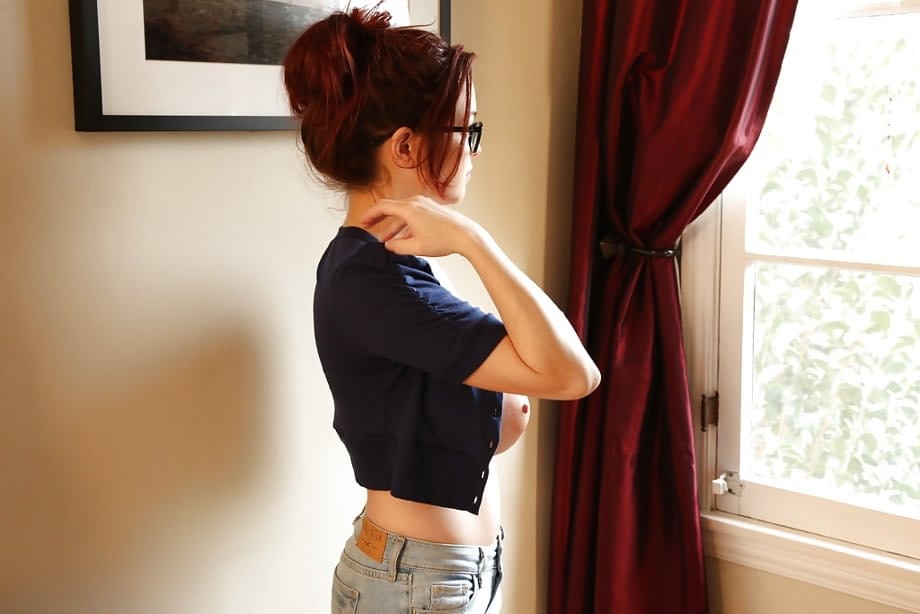 Redhead pornstar Tessa Fowler unveiling perfect knockers in glasses