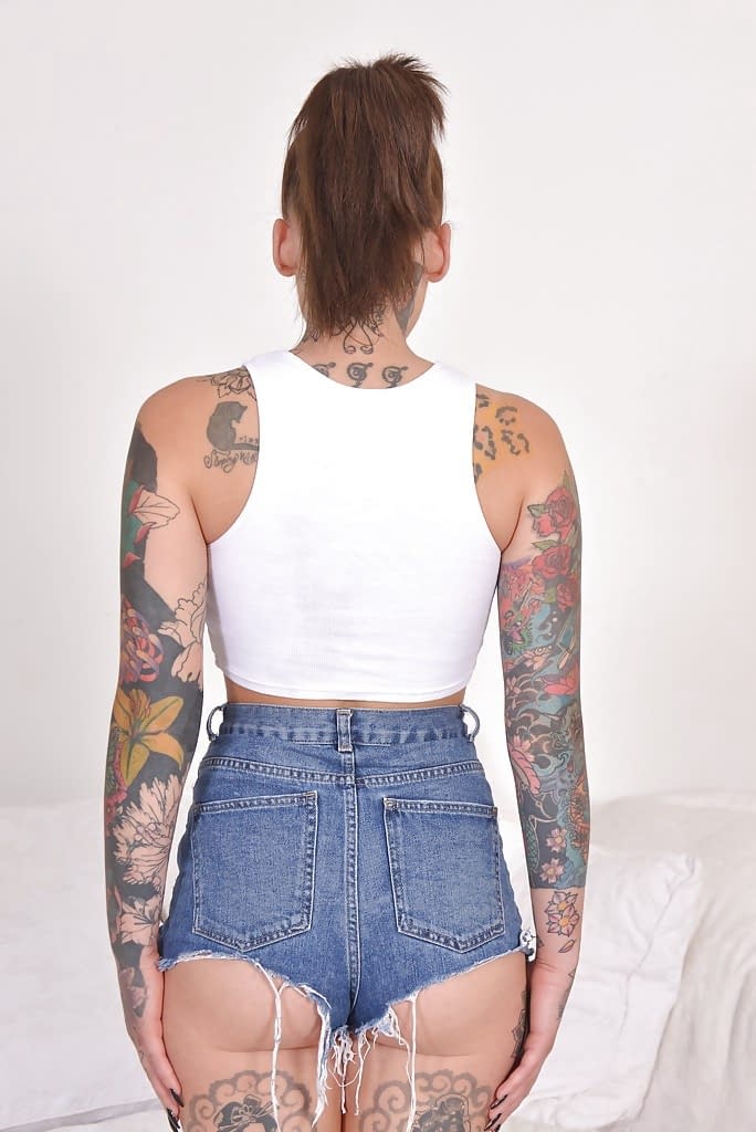 Heavily tattooed alt model Lauren revealing pierced cunt while posing naked