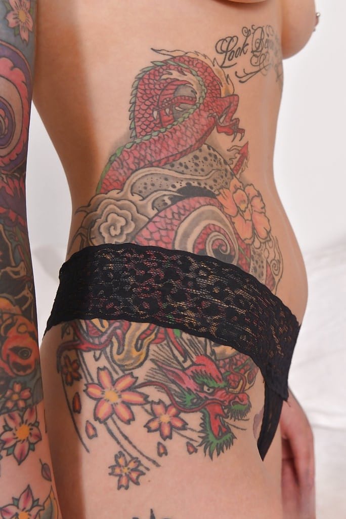Heavily tattooed alt model Lauren revealing pierced cunt while posing naked