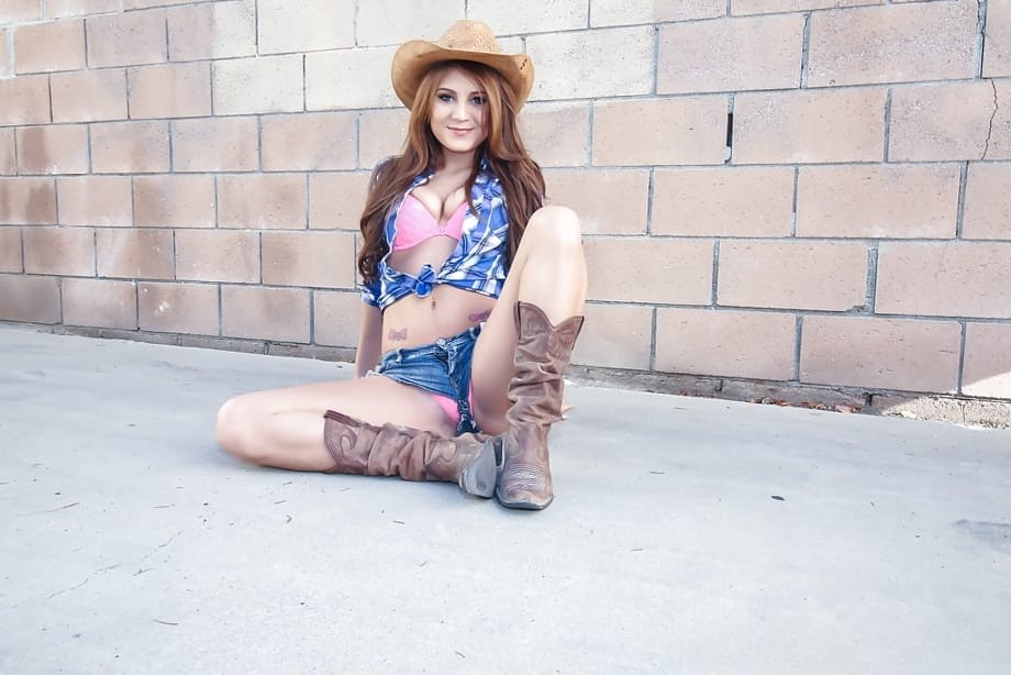 Farm girl Jojo Kiss strips off cutoff shorts to pose naked in boots and hat