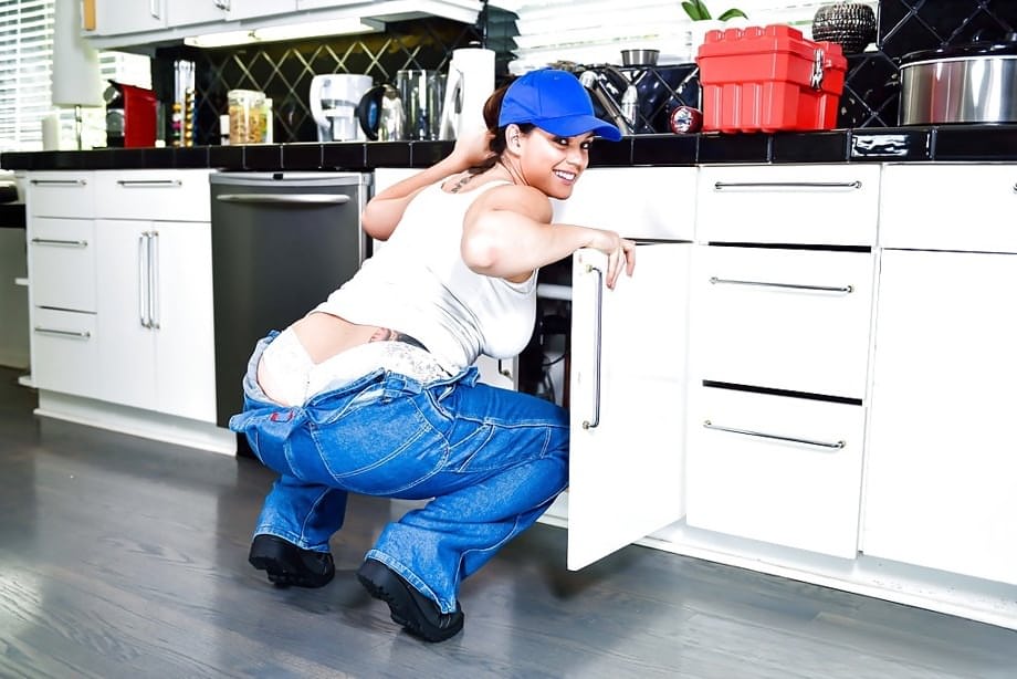 Chunky pornstar Alison Tyler frees big boobs from denim overalls in kitchen