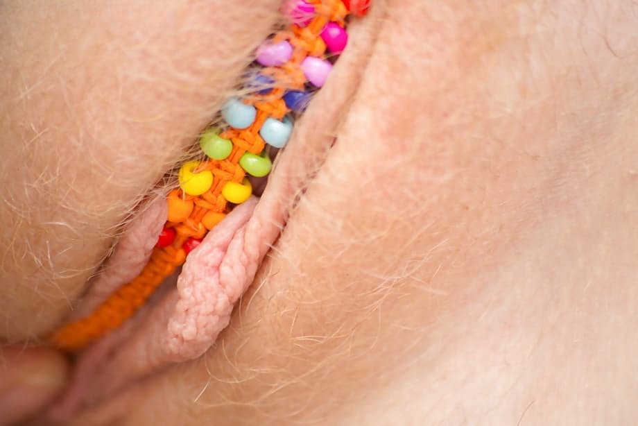 All natural redhead Emma B parting labia lips after undressing on patio