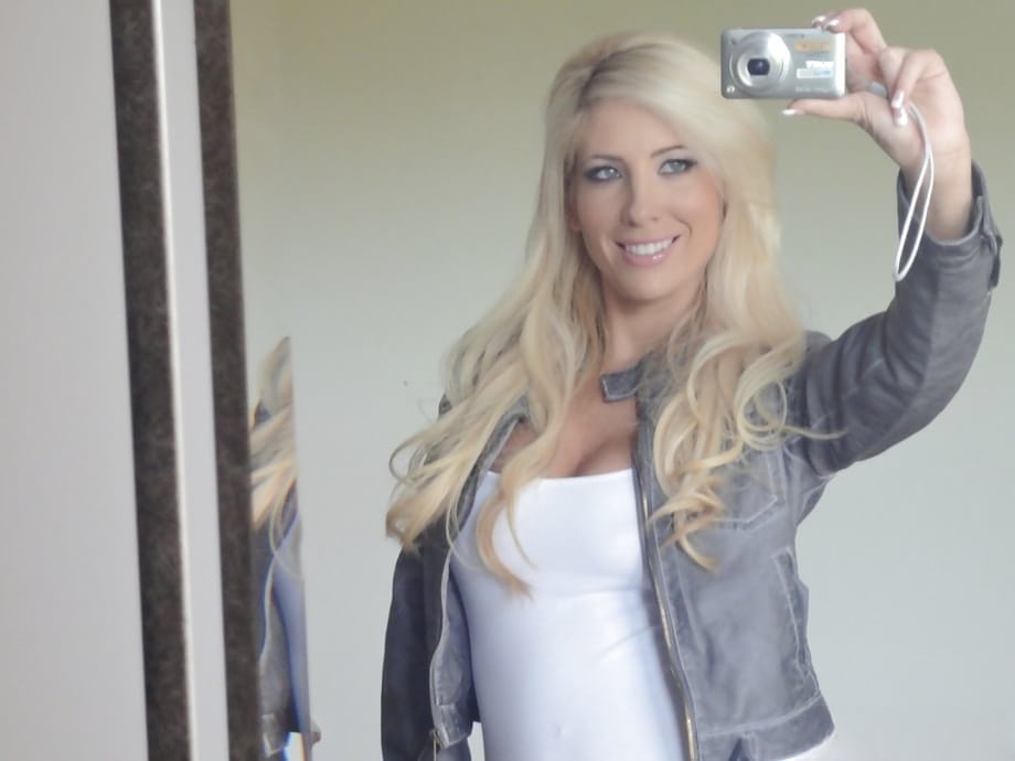Platinum blonde beauty Tasha Reign taking selfies while getting naked