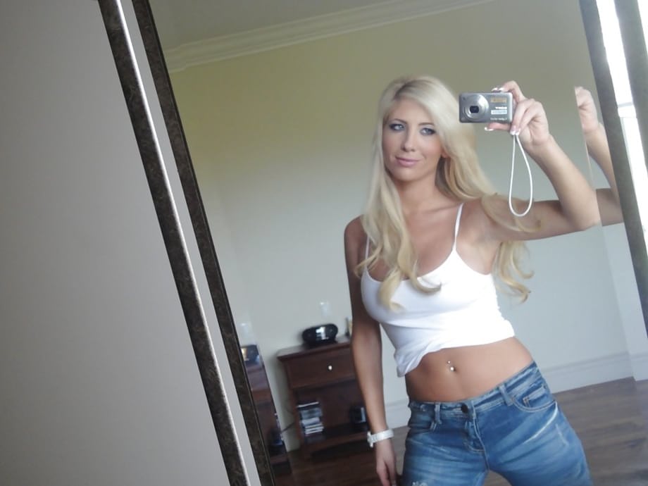 Platinum blonde beauty Tasha Reign taking selfies while getting naked