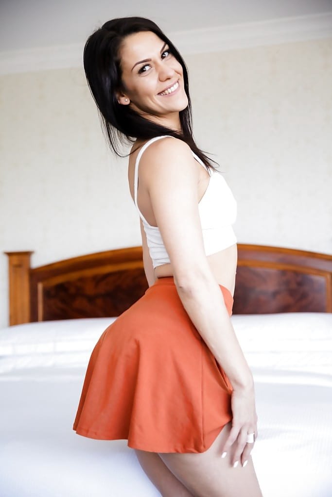 Dark haired chick letting sexy big butt free from assless underwear and skirt