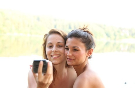 Barely legal Euro girls take selfies while masturbating on lakeside dock