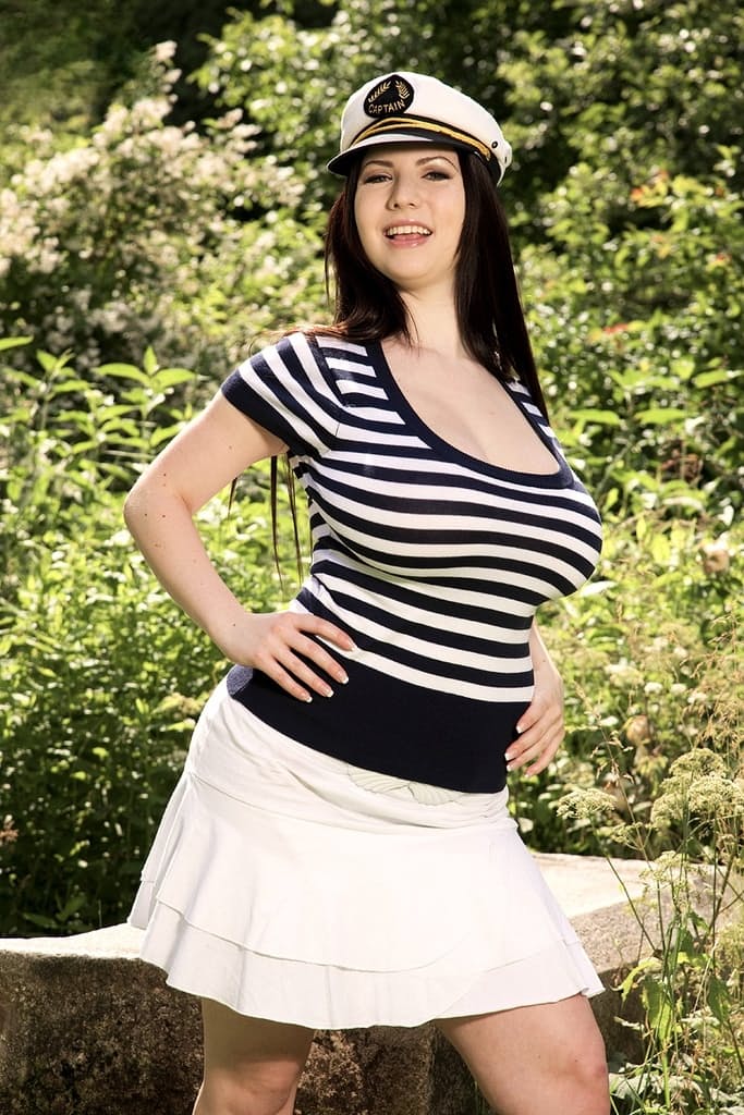 Chubby Euro female Karina Hart showing off huge natural tits in forest