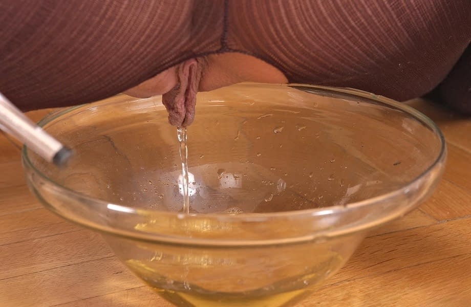 Hot chick Sandy pisses into a glass dish wearing a crotchless bodystocking