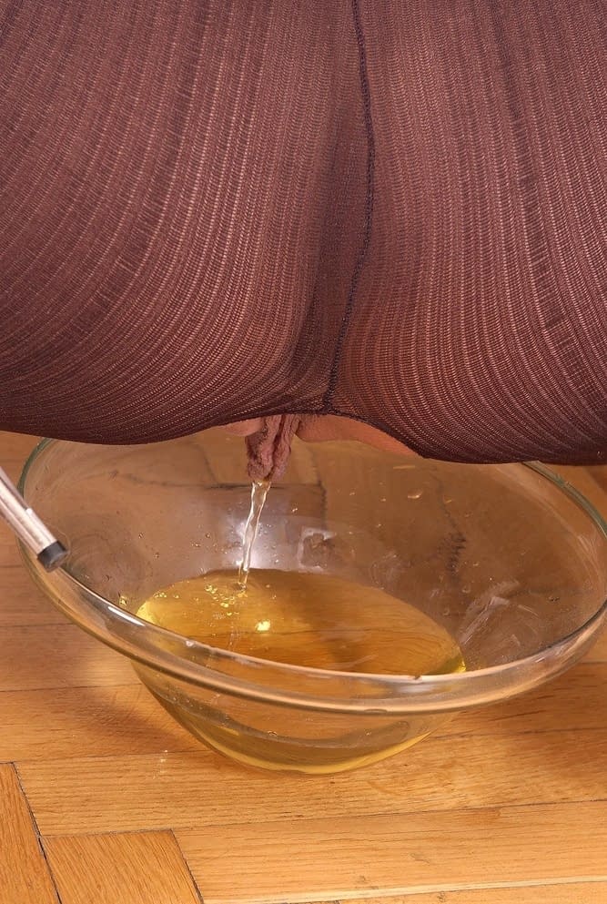 Hot chick Sandy pisses into a glass dish wearing a crotchless bodystocking