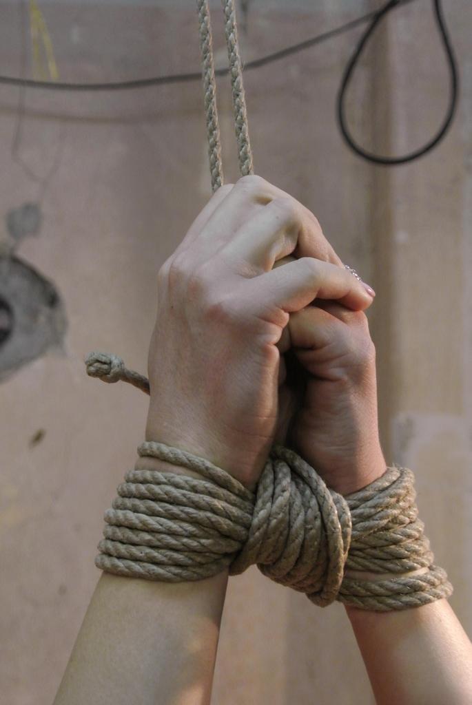 Blonde chick is stripped naked and masturbated with hands tied above her head