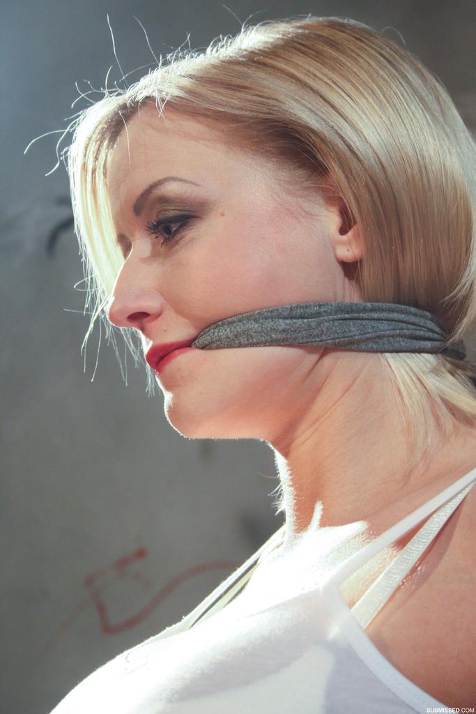 Tied and gagged female has her big tits and erect nipples exposed for her