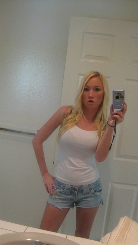 Blonde chick Madison Scott takes selfies as she undresses with a sex doll