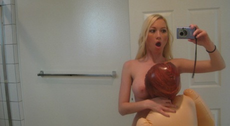 Blonde chick Madison Scott takes selfies as she undresses with a sex doll
