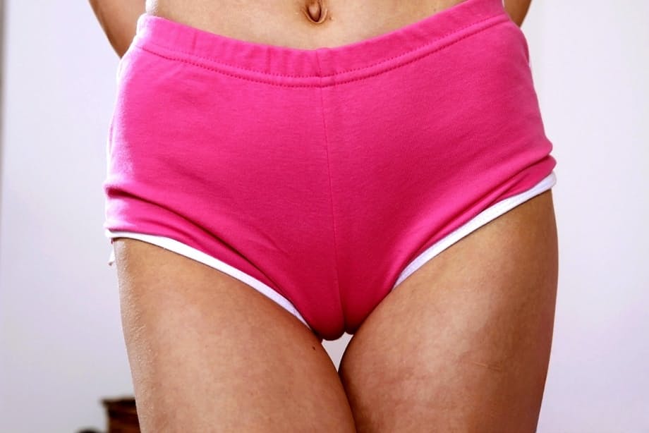 Platinum blonde chick Molly Mae bares her tits before slipping off pink shorts