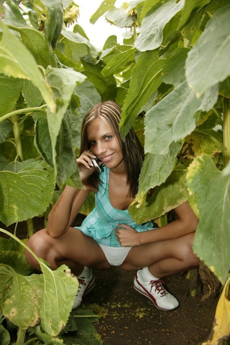 Cute amateur girl toys her teen pussy on a blanket among the foliage