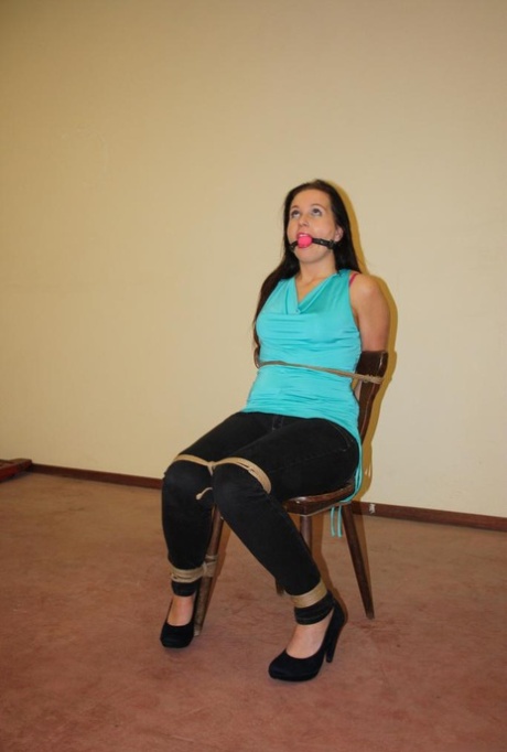 Ball gagged brunette is left all alone tied to a chair with ropes