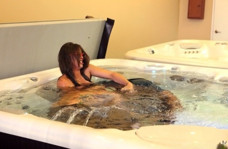Amateur female is stripped naked for sex games in a hot tub