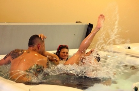 Amateur female is stripped naked for sex games in a hot tub