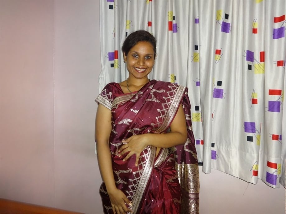 Clothed Indian woman strips to her black bra and underskirt