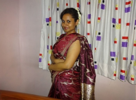 Clothed Indian woman strips to her black bra and underskirt