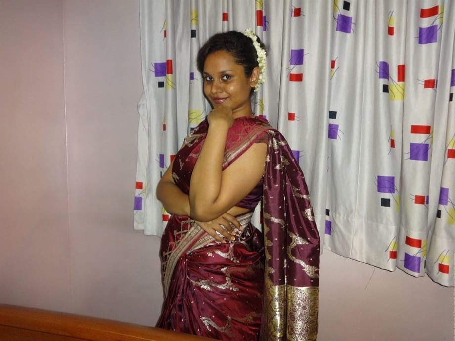 Clothed Indian woman strips to her black bra and underskirt