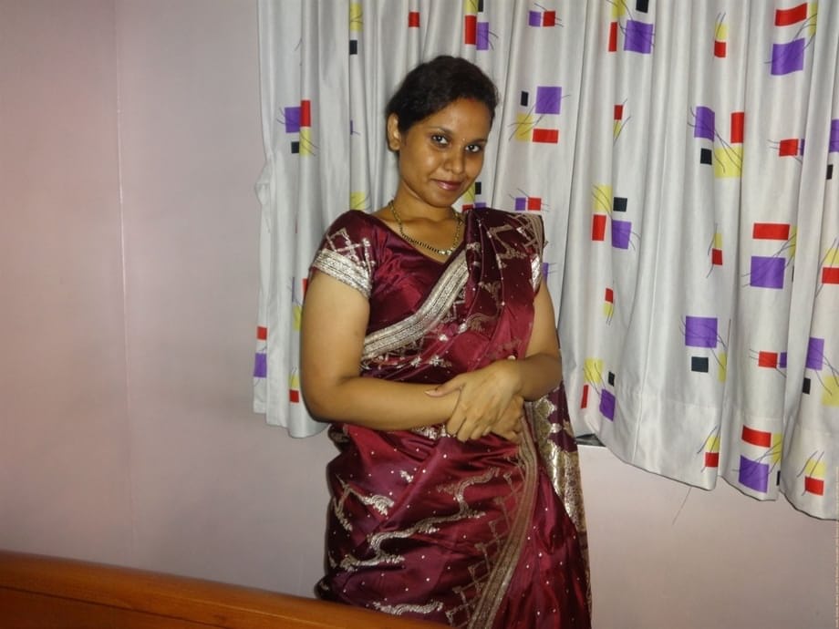 Clothed Indian woman strips to her black bra and underskirt