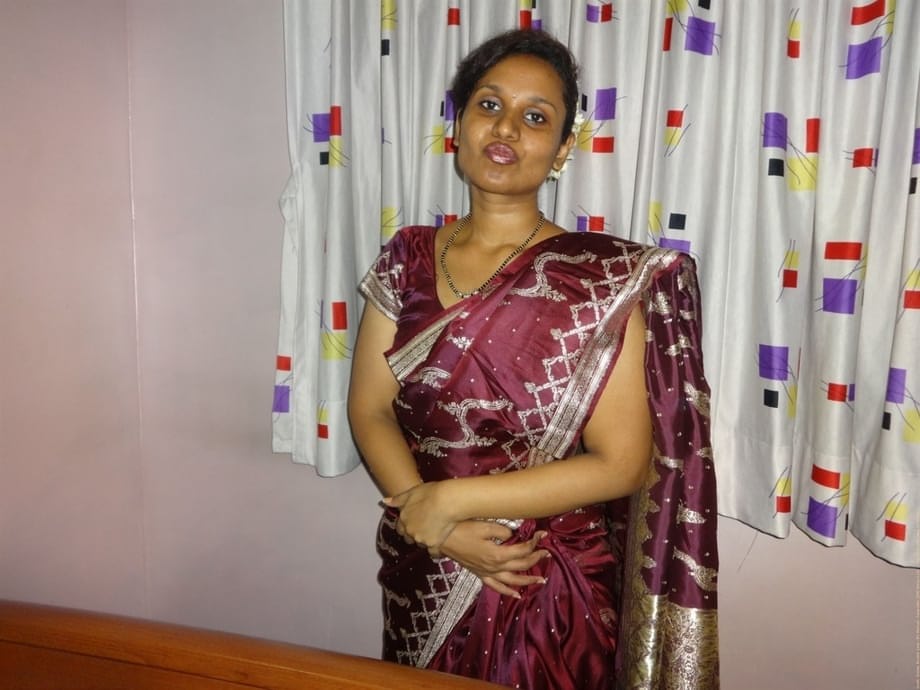 Clothed Indian woman strips to her black bra and underskirt