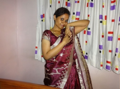Clothed Indian woman strips to her black bra and underskirt