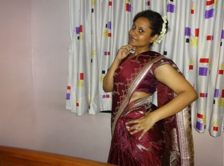 Clothed Indian woman strips to her black bra and underskirt