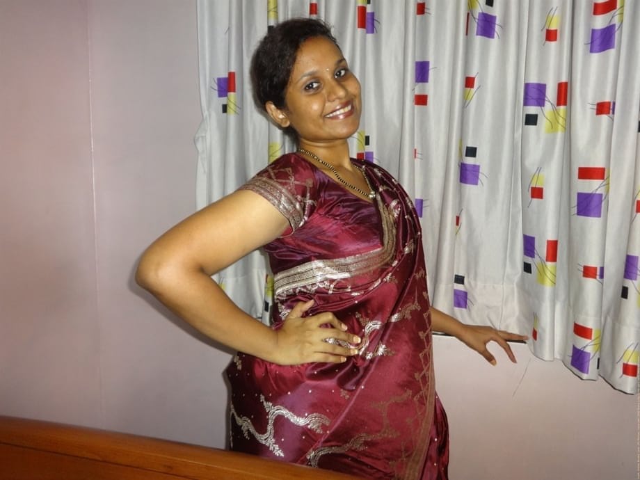 Clothed Indian woman strips to her black bra and underskirt