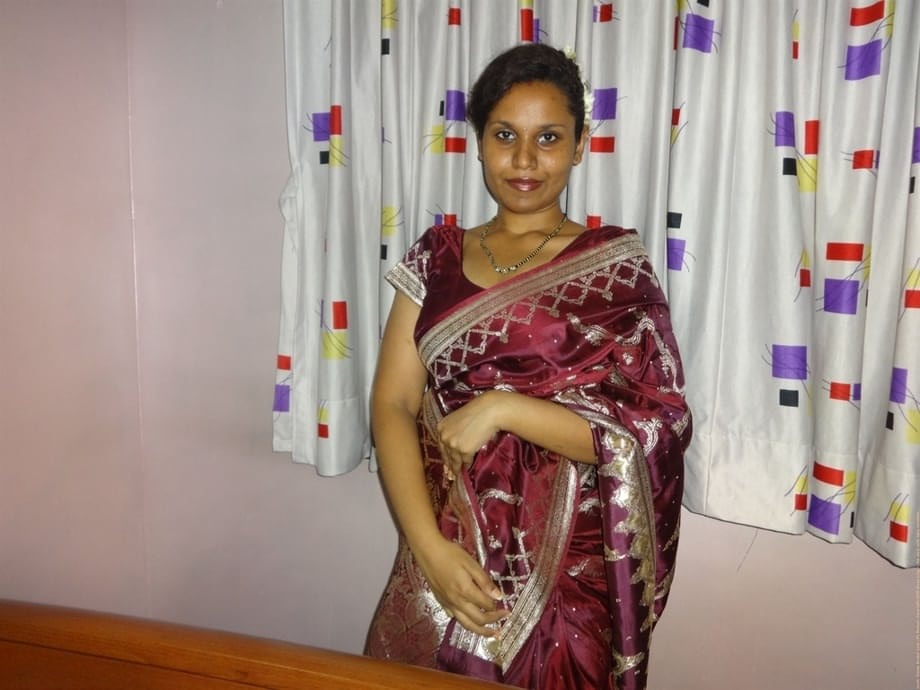 Clothed Indian woman strips to her black bra and underskirt