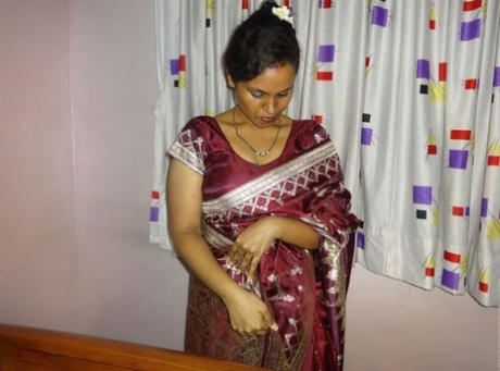 Clothed Indian woman strips to her black bra and underskirt
