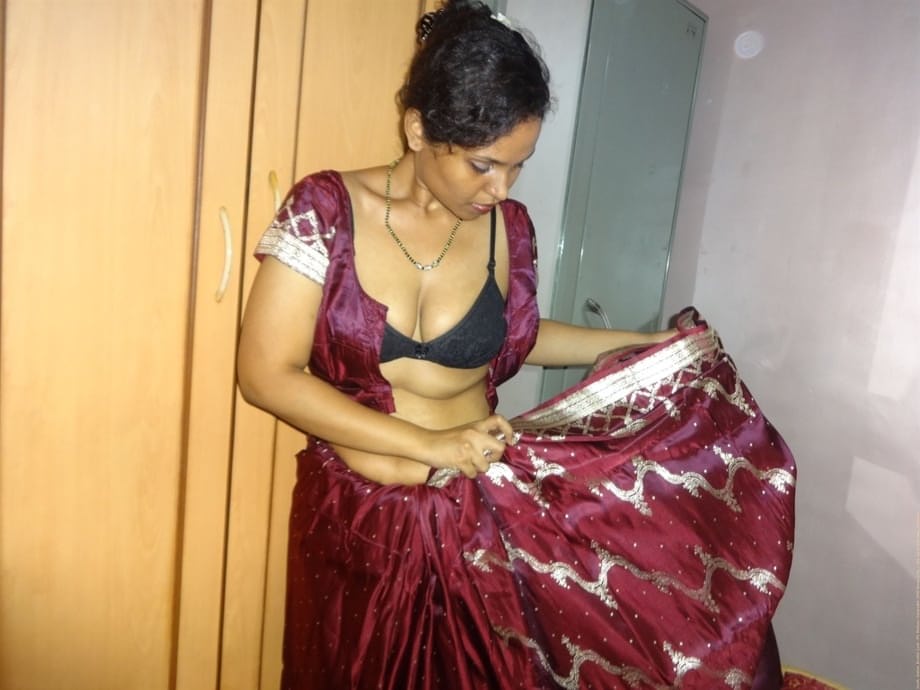 Clothed Indian woman strips to her black bra and underskirt