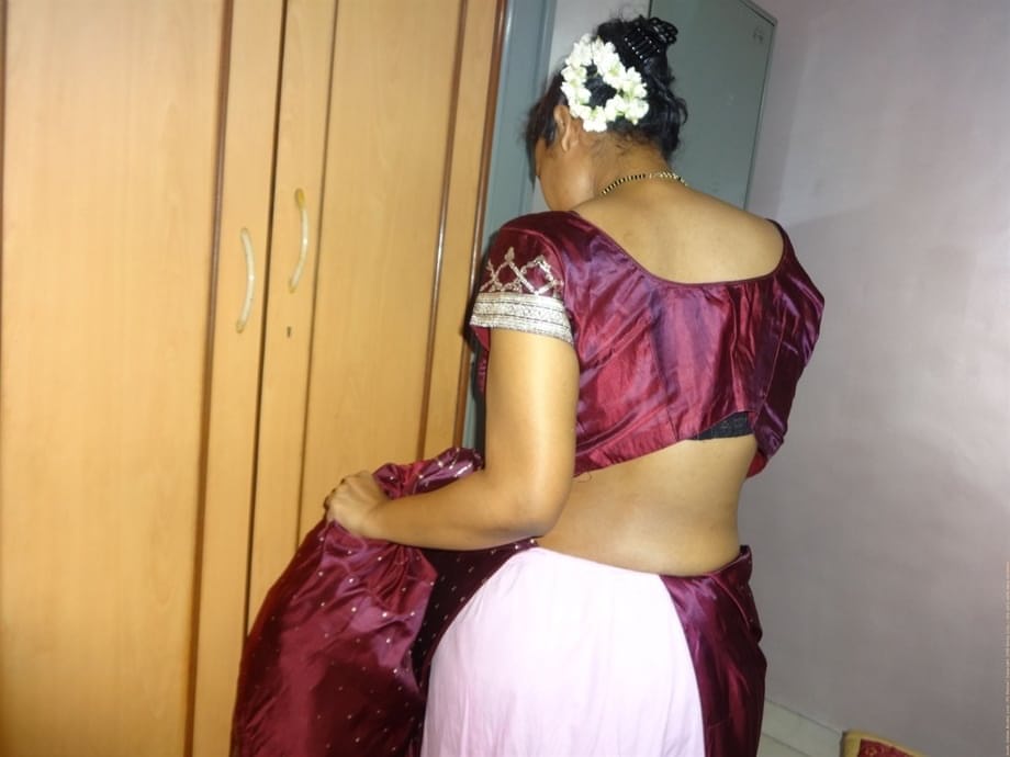 Clothed Indian woman strips to her black bra and underskirt