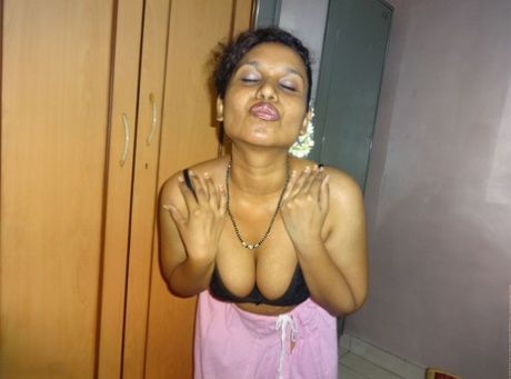 Clothed Indian woman strips to her black bra and underskirt