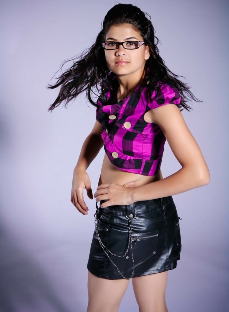 Nerdy Indian girl covers her naked breasts with her hands in a thong