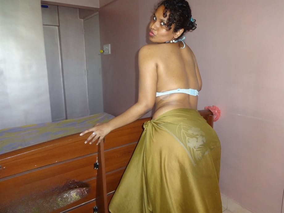 Indian woman lets a boob slip loose from her bra while being a tease