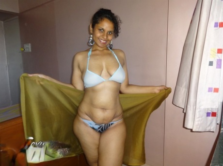 Indian woman lets a boob slip loose from her bra while being a tease