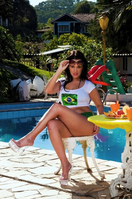 Brazilian MILF Randi Lane exposes her big ass and tits by the pool