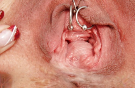 Nasty granny in glasses masturbating her muff and pissing