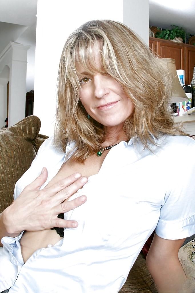 Hot mature lady in mini skirt shows off her big tits and wet shaved pussy.