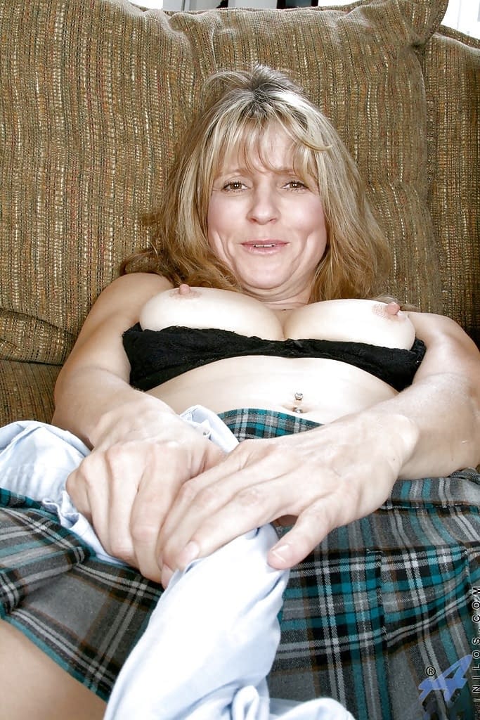 Hot mature lady in mini skirt shows off her big tits and wet shaved pussy.