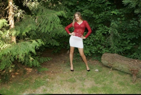 Sexy babe doing upskirt and teasing her cunt under her panties outdoors