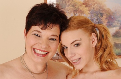 Fuckable granny and her graceful teen girlfriend posing naked together
